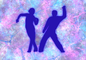 Two people dancing on a colorful backdrop.